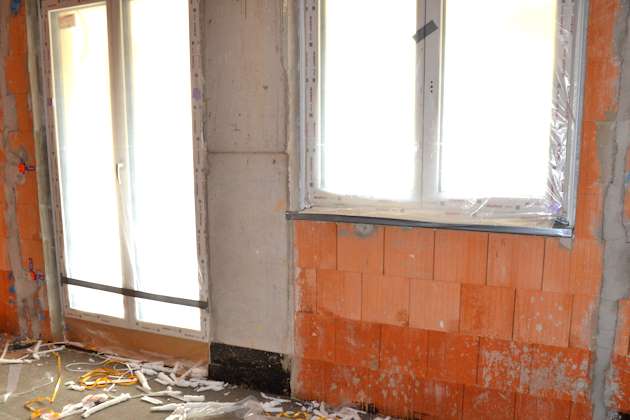 Mit PVC-Folie abgedeckte Fenster in Rohbau